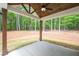 Covered outdoor patio featuring wooden support columns and ceiling fan overlooking the backyard at 110 Doris Path, Dallas, GA 30157