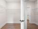 Empty walk-in closet includes white wire shelving, trim, and new flooring at 110 Doris Path, Dallas, GA 30157