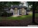 Back of home with large windows, second story deck, and a well-maintained lawn at 2023 Stoneleigh Dr, Stone Mountain, GA 30087