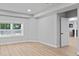 Unfinished basement with light wood floors, a window and a white door at 2023 Stoneleigh Dr, Stone Mountain, GA 30087