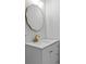 Bathroom vanity with white counter, wavy gold framed mirror, and decorative gold faucet at 2023 Stoneleigh Dr, Stone Mountain, GA 30087
