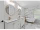 Luxurious bathroom with double vanities, gold fixtures, and a freestanding tub at 2023 Stoneleigh Dr, Stone Mountain, GA 30087