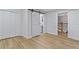 Bright bedroom with laminate flooring and large closets including a sliding barn door to the en-suite bathroom at 2023 Stoneleigh Dr, Stone Mountain, GA 30087