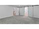 Spacious bedroom featuring new carpet, white trim, and barn door to en suite bathroom at 2023 Stoneleigh Dr, Stone Mountain, GA 30087