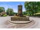 Stone monument marks the entrance to the community with manicured landscaping at 2023 Stoneleigh Dr, Stone Mountain, GA 30087