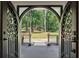 Stunning view through ornate front doors to a lush green lawn and trees, blending indoor and outdoor spaces at 2023 Stoneleigh Dr, Stone Mountain, GA 30087