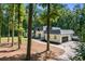 Exterior view of the house surrounded by trees and a circular driveway at 2023 Stoneleigh Dr, Stone Mountain, GA 30087