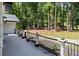 Inviting porch view with black railings and manicured garden beds, offering a peaceful outdoor space at 2023 Stoneleigh Dr, Stone Mountain, GA 30087