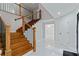 Staircase featuring wood steps, iron railing, and marble floors at 2023 Stoneleigh Dr, Stone Mountain, GA 30087