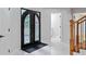 Bright and modern foyer with marble floors, a staircase, and decorative front doors for a stylish entrance at 2023 Stoneleigh Dr, Stone Mountain, GA 30087