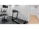 Home gym featuring various exercise machines, mirrored wall and convenient access to side rooms at 2023 Stoneleigh Dr, Stone Mountain, GA 30087