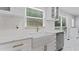 Bright kitchen with marble countertops, farmhouse sink and gold hardware accents at 2023 Stoneleigh Dr, Stone Mountain, GA 30087