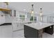 Modern kitchen featuring white cabinetry, a large island, and stainless steel appliances for culinary enthusiasts at 2023 Stoneleigh Dr, Stone Mountain, GA 30087