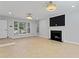 Spacious living room featuring a fireplace and stylish light fixtures at 2023 Stoneleigh Dr, Stone Mountain, GA 30087