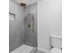 Modern shower with gray tile surround, hexagon tile niche and floor, plus gold fixtures at 2023 Stoneleigh Dr, Stone Mountain, GA 30087