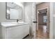 Bright bathroom featuring white vanity and sink, contemporary fixtures, and a modern mirror at 3139 Alston Dr, Decatur, GA 30032