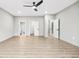 Spacious bedroom with multiple doors, light walls, luxury vinyl plank flooring, and a modern ceiling fan at 3139 Alston Dr, Decatur, GA 30032