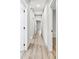 Hallway with many white doors, LVP flooring, and light neutral colored walls at 3139 Alston Dr, Decatur, GA 30032