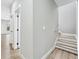 Hallway featuring a staircase, wood-look floors, light walls, and white trim at 3139 Alston Dr, Decatur, GA 30032