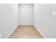 Narrow hall with light-tone walls, wood-look flooring, and white trim at 3139 Alston Dr, Decatur, GA 30032