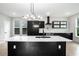 Modern kitchen with black cabinets, white countertops, an island with sink and pendant lighting at 3139 Alston Dr, Decatur, GA 30032