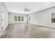 Bright, spacious living room with natural light, wood-look flooring, and a modern ceiling fan at 3139 Alston Dr, Decatur, GA 30032
