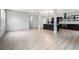 Bright, open-concept living area with modern wood floors and a glimpse into the sleek, black kitchen at 3139 Alston Dr, Decatur, GA 30032