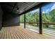 Cozy back porch featuring wooden flooring, a ceiling fan, and a scenic view at 3139 Alston Dr, Decatur, GA 30032