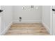 Small empty room with wood-look flooring, white trim, and utility hookups at 3139 Alston Dr, Decatur, GA 30032