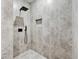 Contemporary shower with gray tile walls, a rainfall showerhead, and a built-in niche at 3139 Alston Dr, Decatur, GA 30032