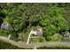 Aerial view of a home nestled among lush trees showcasing the spacious lot and surrounding nature at 33 Kay Ne Rd, White, GA 30184
