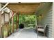 Covered patio with a seating area, barbecue, and views of the spacious backyard at 33 Kay Ne Rd, White, GA 30184