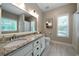 Well-lit bathroom boasts double sinks, granite countertops, and tiled floors at 33 Kay Ne Rd, White, GA 30184