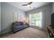 Relaxing bedroom includes a gray couch and large window with backyard views at 33 Kay Ne Rd, White, GA 30184