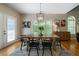Cozy dining room with rustic wooden table, decorative light fixture, and access to outdoor patio at 33 Kay Ne Rd, White, GA 30184