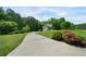 Charming home exterior with lush landscaping, a long driveway, and a well-manicured lawn at 33 Kay Ne Rd, White, GA 30184