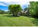 Exterior of home with large, well-manicured lawn and mature trees creating a serene setting at 33 Kay Ne Rd, White, GA 30184