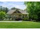 Charming home with stone accents, covered porch, and beautifully landscaped front yard and walkway at 33 Kay Ne Rd, White, GA 30184