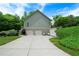 Spacious two-car garage with ample parking and a well-manicured lawn at 33 Kay Ne Rd, White, GA 30184