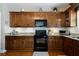 Close up view of a kitchen area with wood cabinets, granite countertops, and stainless steel appliances at 33 Kay Ne Rd, White, GA 30184
