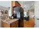 View of the kitchen area with granite countertops and stainless steel appliances, open to the living area at 33 Kay Ne Rd, White, GA 30184