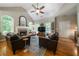 Cozy living room with vaulted ceiling, stone fireplace, hardwood flooring, and ample natural light at 33 Kay Ne Rd, White, GA 30184