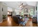 Bright living room featuring vaulted ceilings, hardwood floors, stone fireplace, and large windows at 33 Kay Ne Rd, White, GA 30184