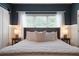 Comfortable main bedroom featuring large windows, soft lighting, and calming, neutral color scheme at 33 Kay Ne Rd, White, GA 30184