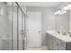 Modern bathroom featuring double sinks, a glass-enclosed shower, and marble-like tiles at 800 Ivy Crest Ln, Canton, GA 30115