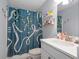 Well-lit bathroom featuring a blue decorative shower curtain and a white vanity at 800 Ivy Crest Ln, Canton, GA 30115