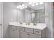 Well-lit bathroom with double vanity, gray cabinets, and a glass-enclosed shower at 800 Ivy Crest Ln, Canton, GA 30115