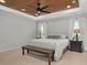 Inviting bedroom featuring a decorative wood tray ceiling, carpet floors, and lamps at 800 Ivy Crest Ln, Canton, GA 30115