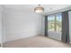 Bright bedroom featuring a large window with gray curtains and modern light fixture at 800 Ivy Crest Ln, Canton, GA 30115