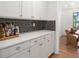 Convenient butler's pantry features sleek white cabinets, quartz countertops, and stylish backsplash at 800 Ivy Crest Ln, Canton, GA 30115